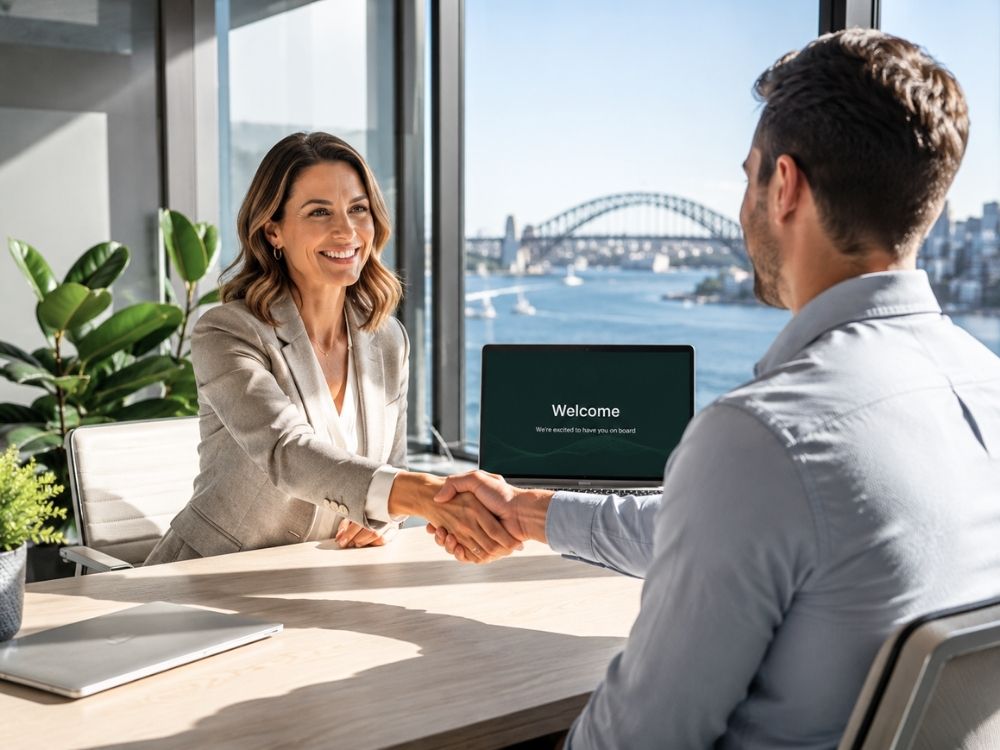Professional HR manager welcoming a new hire to a Sydney office, illustrating a seamless employee onboarding process managed through HR Command.