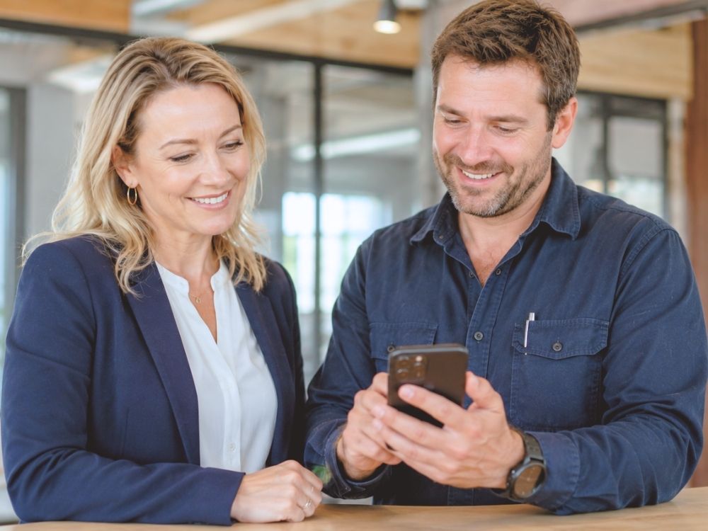 A supervisor and worker using HR Command on a smartphone to log a real-time hazard, demonstrating the simplicity of mobile-first WHS Management for site-based teams.