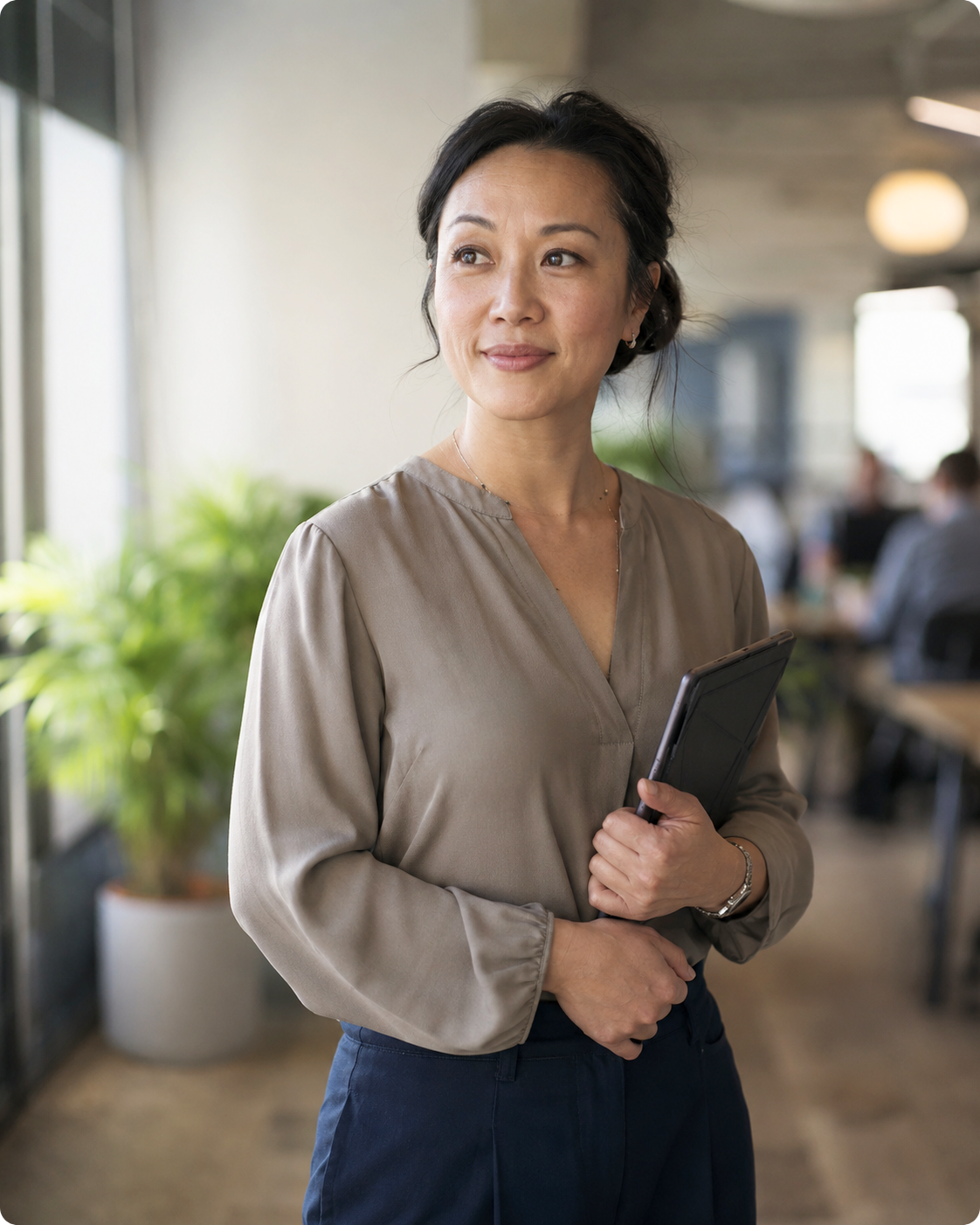 Confident HR manager holding a tablet in an office, using HR Command's custom HR template builder for compliant contracts