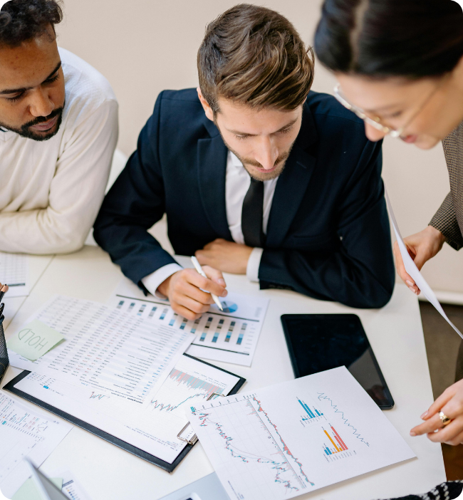 Business team reviewing reports and charts together, representing an all-in-one HR platform with contracts, policies and expert advice for Australian businesses