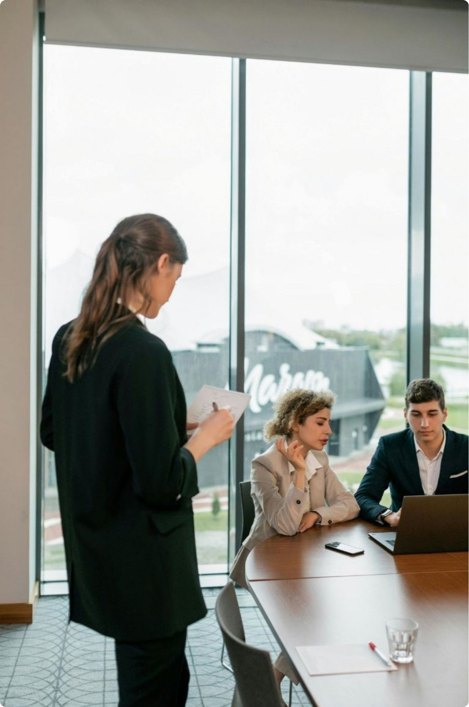 HR professional presenting to two colleagues in a boardroom, representing Fair Work compliant HR support for Australian associations and their members