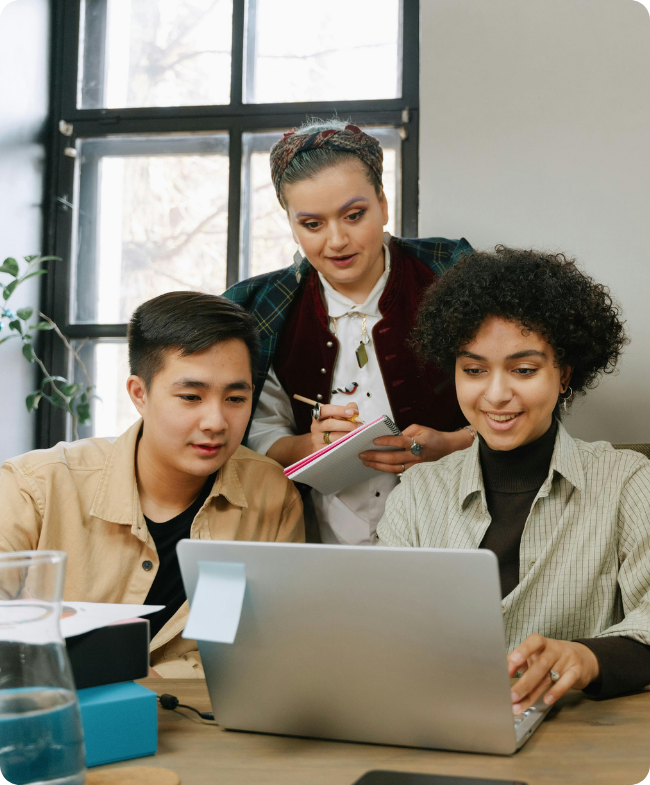 Three colleagues looking at a laptop together in a bright office, representing a centralised HR document library and compliance tools for Australian SMEs