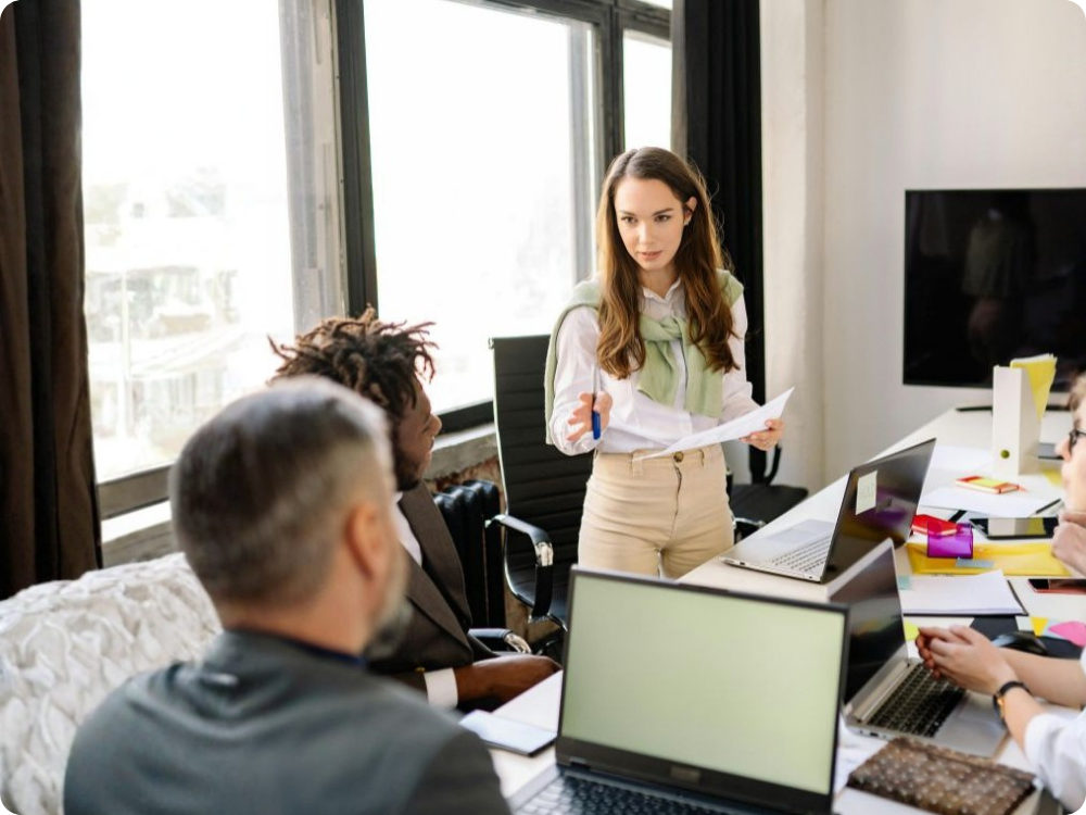 HR professional presenting to colleagues in a modern office, representing HR compliance software for Australian businesses and workforce specialists