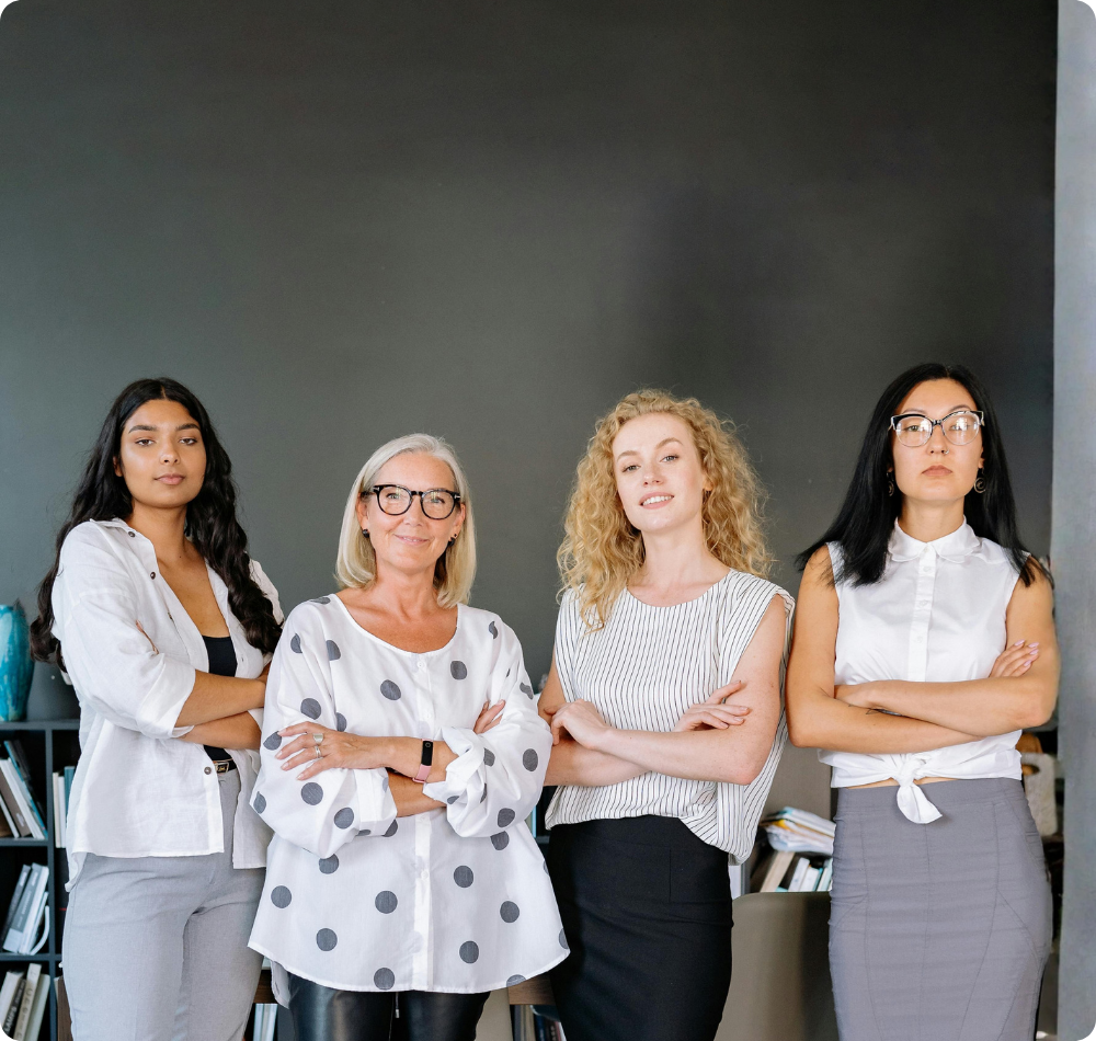 Four confident HR professionals standing together in an office, representing an all-in-one HR platform that helps Australian HR teams grow their strategic influence
